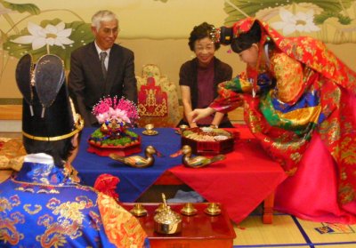 Mr. Kato and Ms. Watanabe stand in as parents for the bride and groom, who are both former North Korean orphan refugees.