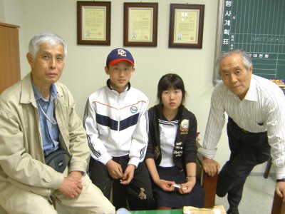 The Choi children, one year later, with Kato Hiroshi and Kim Sang-hun, a South Korean humanitarian aid worker.