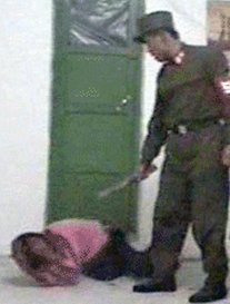 Guard beats female prisoner
