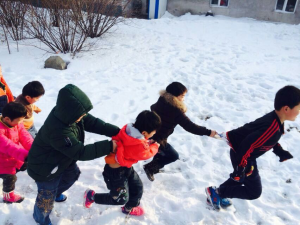 Chol enjoys playing with his elder sisters and brothers at the orphanage